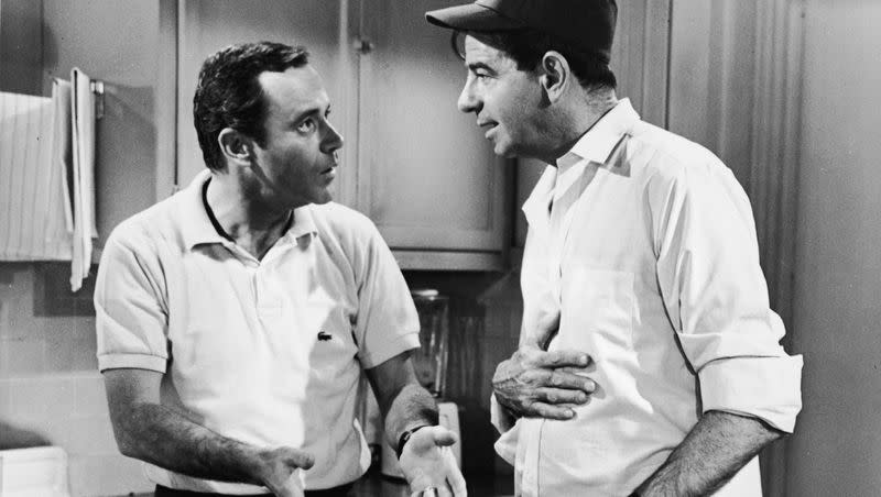 Actor Jack Lemmon, as Felix Unger, stands in a kitchen and talks to actor Walter Matthau, as Oscar Madison, in a still from the film “The Odd Couple” in 1968.