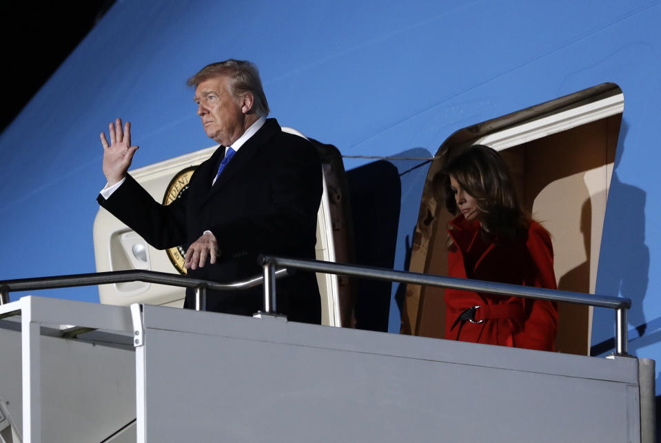 U.S. President Donald Trump waves as he and U.S. first lady Melania Trump arrive at Stansted Airport in England, Monday, Dec. 2, 2019. US President Donald Trump will join other NATO heads of state at Buckingham Palace in London on Tuesday to mark the NATO Alliance's 70th birthday. (AP Photo/Evan Vucci)