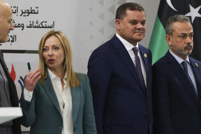 Italian Prime Minister Giorgia Meloni stands next to one of the Libya's rival prime ministers Abdul Hamid Dbeib, right, a during a conference in Tripoli, Libya, Saturday, Jan. 28, 20223. (AP Photo/Yousef Murad)