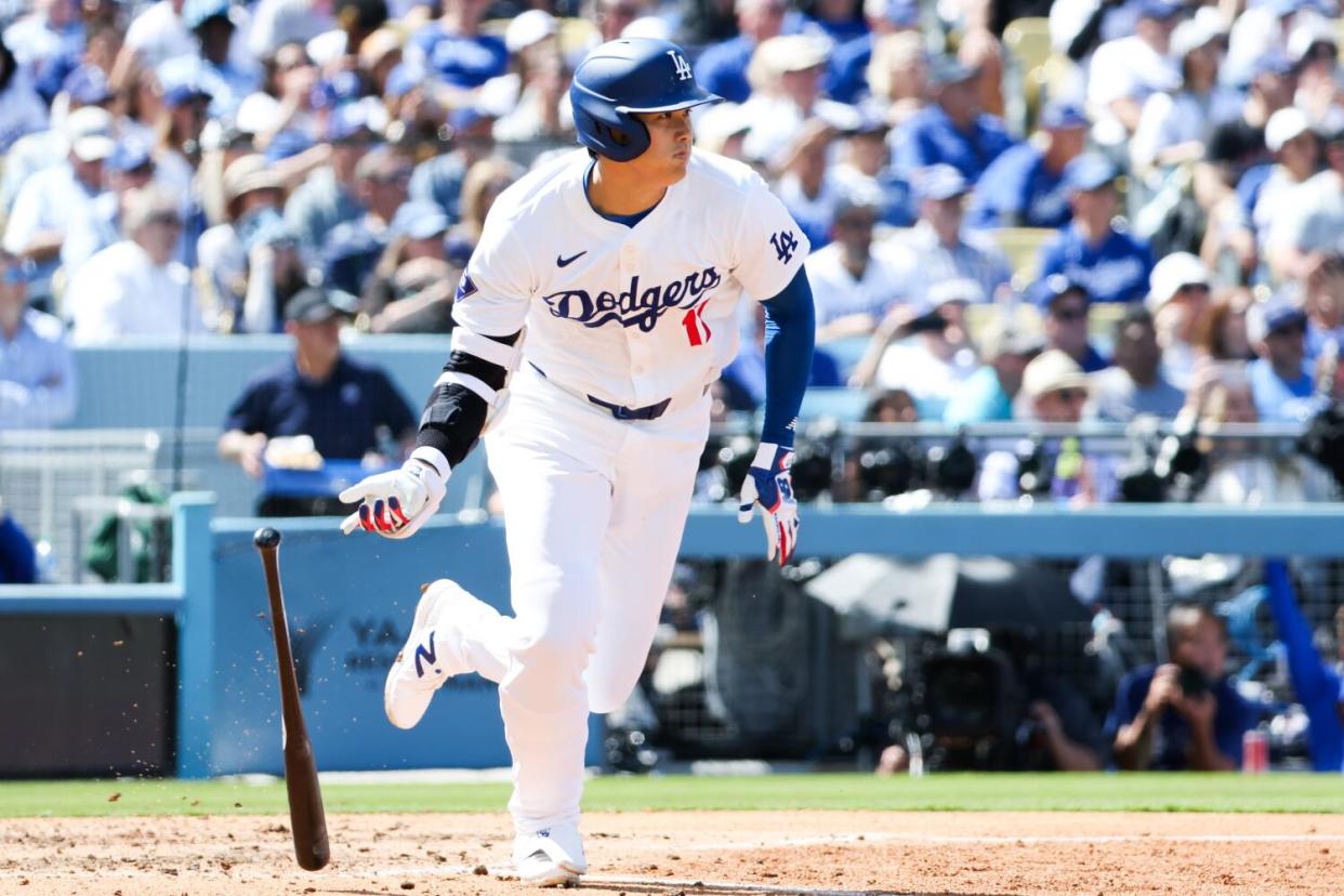 Dodgers star Shohei Ohtani tosses his bat after hitting a single in the fifth inning Thursday.