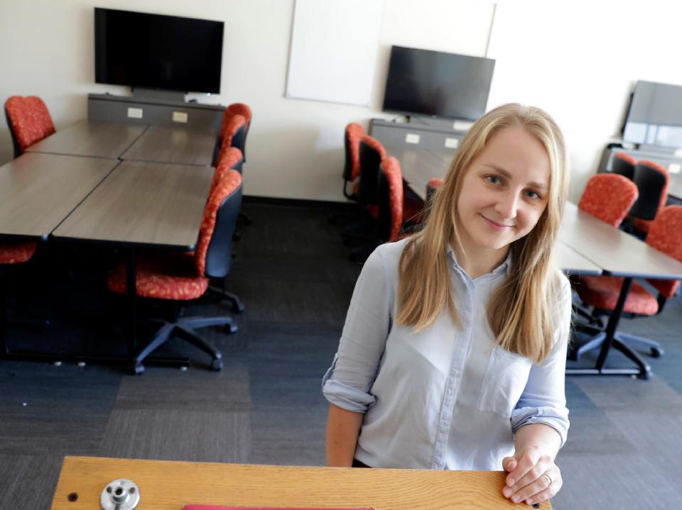 Oksana Katsanivska poses in a classroom Sept. 30, 2022, at the University of Wisconsin-Oshkosh. Katsanivska arrived in August from Ukraine with her family to flee the war in Ukraine. Her connections to a UW-Oshkosh professor brought her to the university.