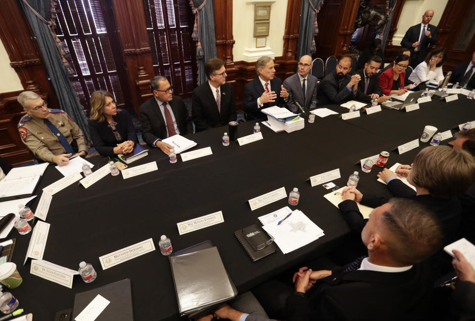 Texas Gov. Greg Abbott, top center, makes opening statements during a round table discussion, Thursday, Aug. 22, 2019, in Austin, Texas. Abbott is meeting in Austin with officials from Google, Twitter and Facebook as well as officials from the FBI and state lawmakers to discuss ways of combatting extremism in light of the recent mass shooting in El Paso that reportedly targeted Mexicans. (AP Photo/Eric Gay)