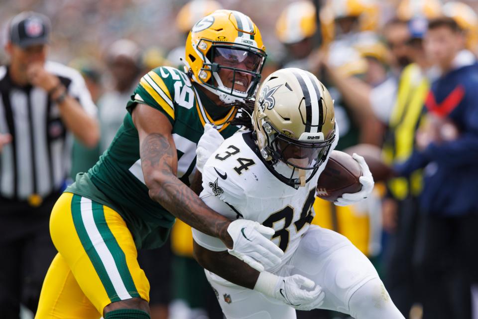 New Orleans Saints running back Tony Jones Jr. (34) is tackled by Green Bay Packers cornerback Rasul Douglas (29) during the first quarter at Lambeau Field.