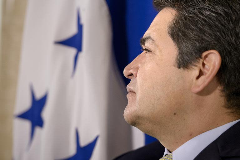 President of Honduras Juan Orlando Hernandez listens to questions from reporters on June 17, 2015 in Washington, DC