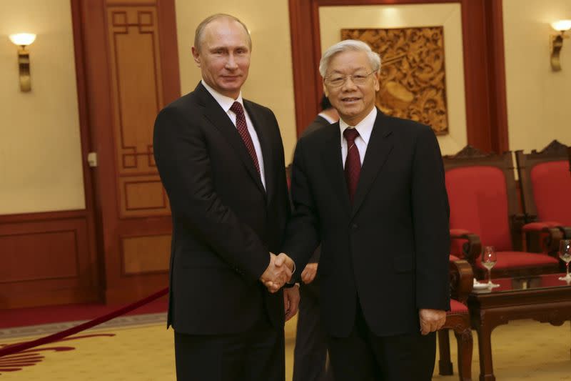 Russian President Putin shakes hand with Vietnamese Communist Party General Secretary Nguyen in Hanoi