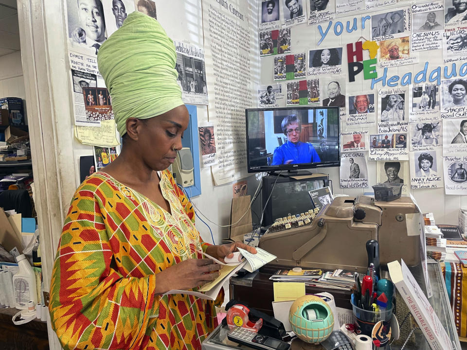 Maati Jone Primm looks down at her notes in her store Marshall's Music and Bookstore in Farish Street Historic District, Thursday, Sept. 1, 2022 in Jackson, Miss. She said white flight is at the root of Jackson's water woes. (AP Photo/Michael Goldberg)