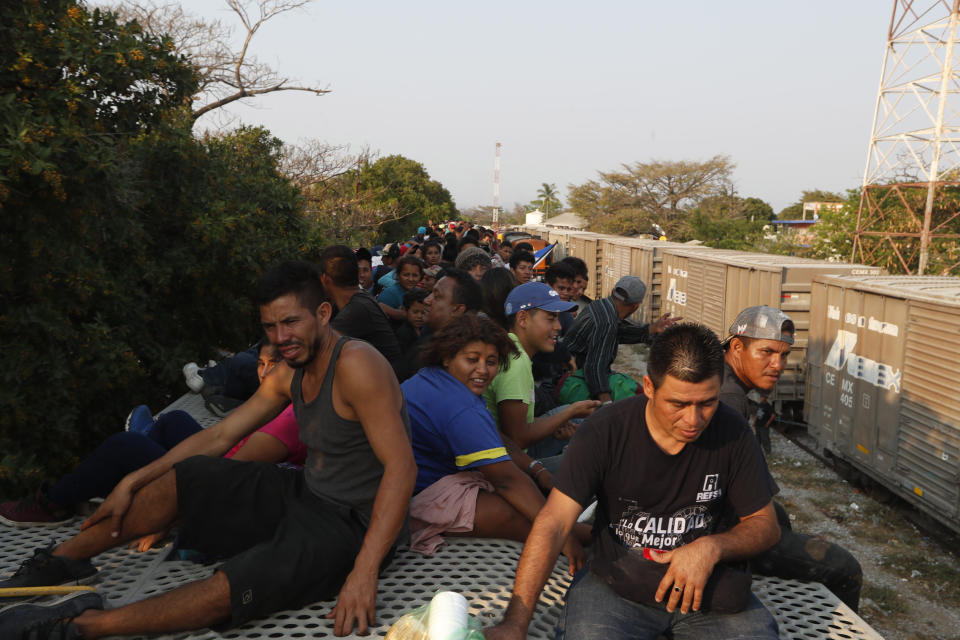 Central American migrants ride atop a freight train during their journey toward the US-Mexico border, in Ixtepec, Oaxaca State, Mexico, Tuesday, April 23, 2019. It's not as if the migrants think the train is safe; they acknowledge the dangers of riding through the darkness perched high atop the freight cars. (AP Photo/Moises Castillo)