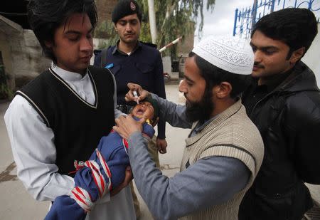 A baby receives polio vaccine drops at a government children's hospital in Peshawar, March 3, 2015. REUTERS/Fayaz Aziz