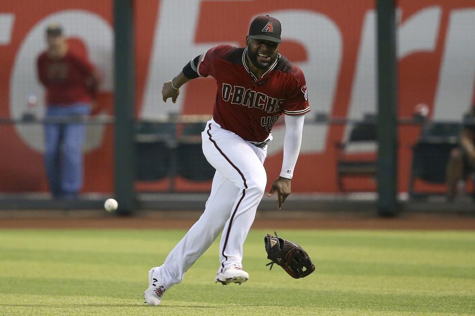 Arizona Diamondbacks right fielder Abraham Almonte injures his leg as he is unable to get to a line drive hit by St. Louis Cardinals' Jose Martinez during the fifth inning of a baseball game Wednesday, Sept. 25, 2019, in Phoenix. Martinez would end up with a triple on the play. (AP Photo/Ross D. Franklin)