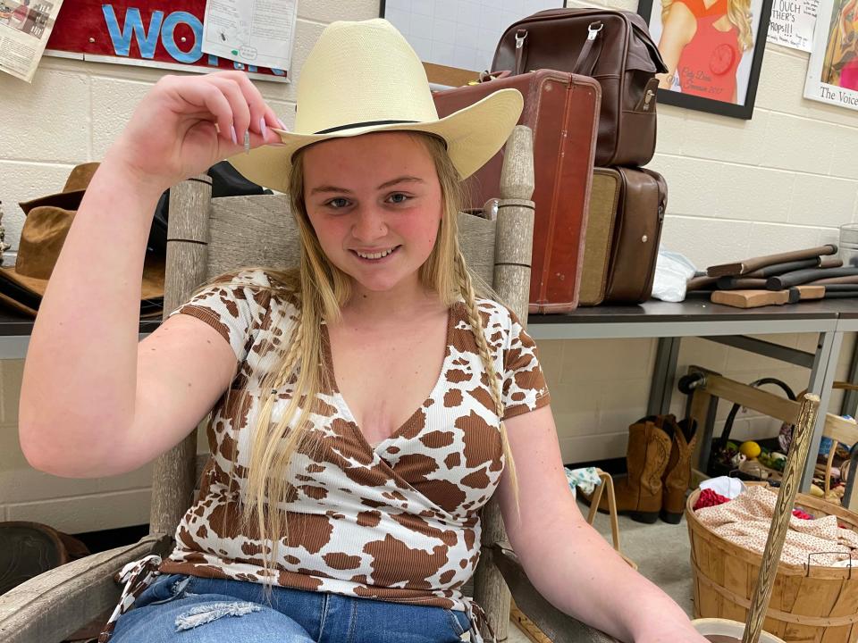 Lexie Derosa (Kate) tries on a multitude of cowboy hats getting ready for the spring production of “Oklahoma!” at Karns High School. 
March 8, 2023.