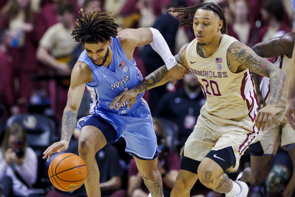 North Carolina guard RJ Davis, left, and Florida State guard Josh Nickelberry (20) chase the ball during the first half of an NCAA college basketball game Saturday, Jan. 27, 2024, in Tallahassee, Fla. (AP Photo/Colin Hackley)
