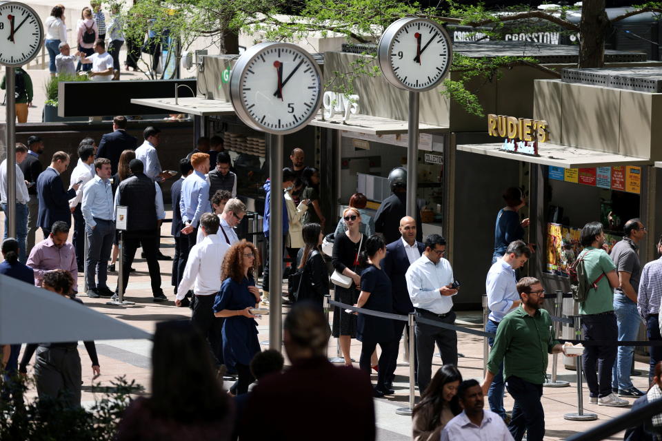 People queue for food in the financial district of Canary Wharf. Business confidence remained steady in September