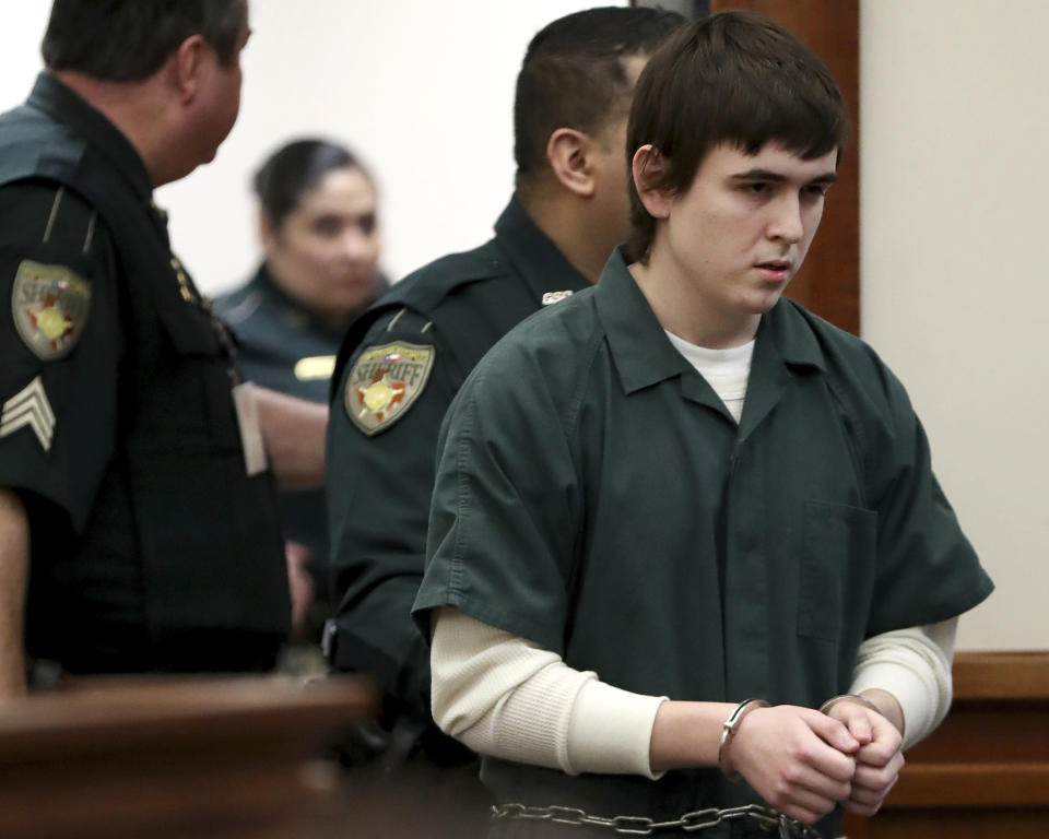 FILE - Dimitrios Pagourtzis is escorted by Galveston County Sheriff's Office deputies into the jury assembly room for a change of venue hearing at the Galveston County Courthouse on Feb. 25, 2019, in Galveston, Texas. Family members of those killed and injured during a 2018 attack at the Texas high school expressed concern Thursday, April 20, 2023, that the case against the accused gunman — delayed for years over questions of his mental competency — could be further held up pending removal of the trial judge, facing allegations of bias and prior legal ties to the defendant. (Jennifer Reynolds/The Galveston County Daily News via AP, Pool, File)