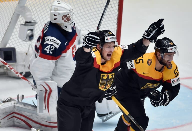 Germany forwards Patrick Hager (C) and Felix Schutzduring (R) celebrate a goal during the group B preliminary round game against Slovakia, in St. Petersburg on May 10, 2016