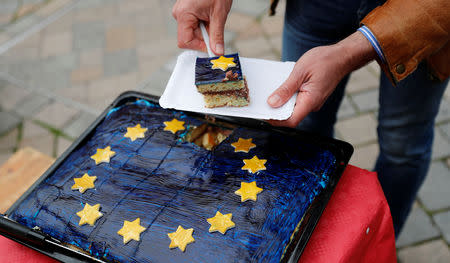 Arne Lietz, candidate of the Social Democratic Party (SPD) for the upcoming European Parliament elections serves a piece of cake as he campaigns in Quedlinburg, Germany, May 4, 2019. Picture taken May 4, 2019. REUTERS/Fabrizio Bensch