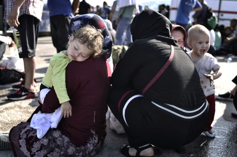 Migrants wait to be transferred to a camp on the Greek island of Lesbos, June 17, 2015