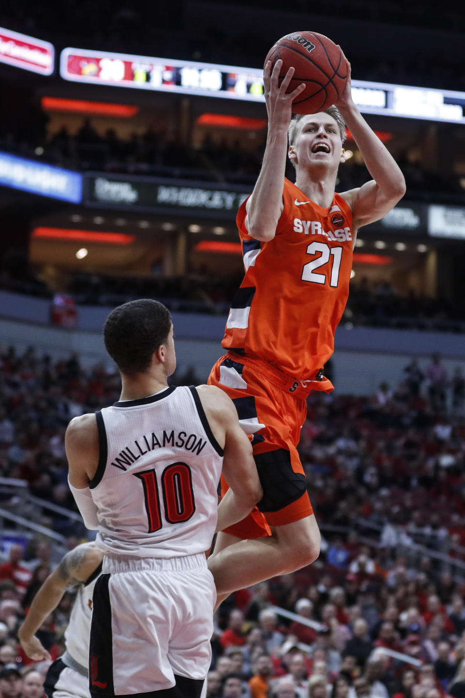 Syracuse forward Marek Dolezaj (21) shoots over Louisville guard Samuell Williamson (10) during the first half of an NCAA college basketball game Wednesday, Feb. 19, 2020, in Louisville, Ky. (AP Photo/Wade Payne)