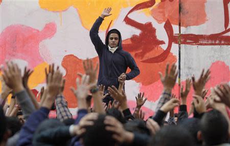 An anti-military protester leads chanting during a rally to commemorate the second anniversary of the deaths of 42 people in clashes with security forces on Mohamed Mahmoud Street, near Tahrir Square in Cairo November 19, 2013. REUTERS/Mohamed Abd El Ghany