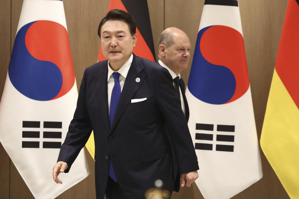 German Chancellor Olaf Scholz, rear, and South Korea's President Yoon Suk Yeol arrive for their meeting at the Presidential Office in Seoul, South Korea Sunday, May 21, 2023. Scholz arrived in Seoul on Sunday for the summit with Yoon after attending the G7 summit in Hiroshima, Japan. (Chung Sung-Jun/Pool Photo via AP)