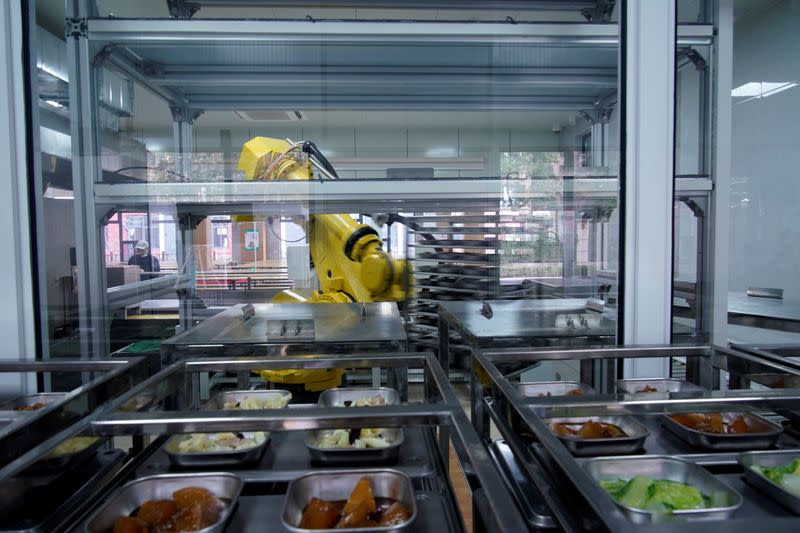 A robot chef makes food for lunch at Minhang Experimental High School amid the global outbreak of the coronavirus disease (COVID-19) in Shanghai