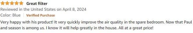 Five-star review with text praising a product for quick improvement in spare bedroom organization, mentioning season change