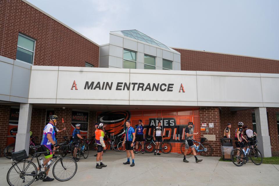 Riders hide from the rain in Ames during the RAGBRAI route inspection ride, Tuesday, June 6, 2023. 