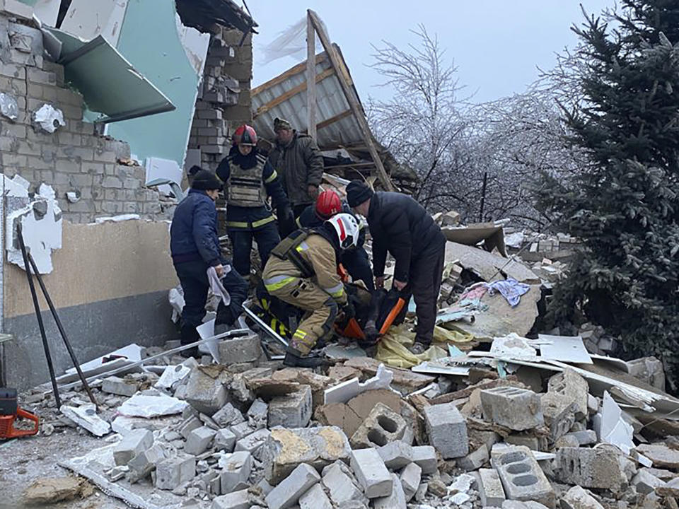 CORRECTS PHOTOGRAPHER NAME, SOURCE AND BYLINE TITLE IN CAPTION HEADERS - In this photo provided by the Ukrainian Emergency Service, rescuers help a wounded person after a residential houses were destroyed by a Russian missile attack, in Novomoskovsk, near Kryvyi Rih, Ukraine, Monday, Jan. 8, 2024. (Ukrainian Emergency Service via AP)