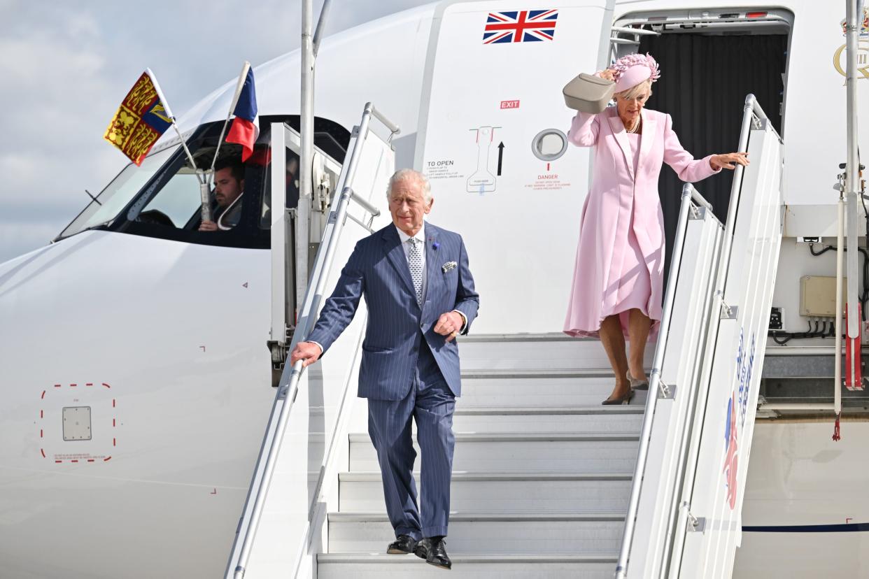 Charles went ahead as Camilla fixed her hat (PA)