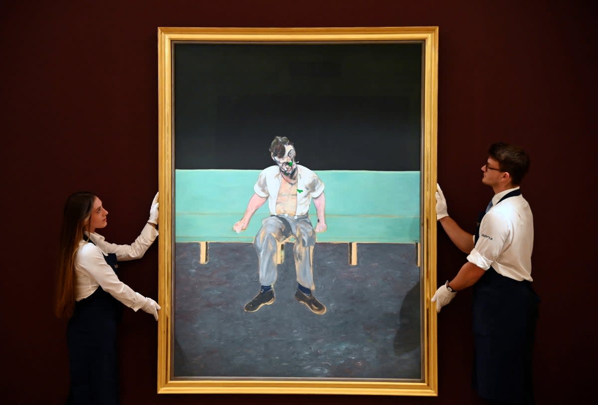 Technicians pose with 'Study for Portrait of Lucian Freud' by Francis Bacon at Sotheby's.  (REUTERS)