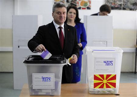 Macedonian President Gjorge Ivanov casts his ballots next to his wife Maja at a polling station in Skopje April 27, 2014. REUTERS/Ognen Teofilovski