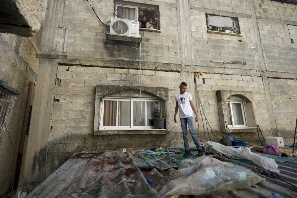 A boy looks at blood stains after a military raid in the Nur Shams refugee camp near the city of Tulkarem, in the occupied West Bank Saturday, May 6, 2023. Israeli forces shot dead two Palestinians during a military raid in the occupied West Bank Saturday, the Palestinian Health Ministry said, while a local armed group said the pair were militants.The ministry and Tulkarem's branch of Al Aqsa Martyrs Brigades, a militant group with connections to President Mahmoud Abbas' Fatah party, identified the pair as Samer El Shafei and Hamza Kharyoush, both aged 22 years. (AP Photo/Majdi Mohammed)