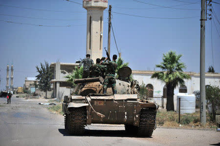 Forces loyal to Syria's President Bashar al-Assad are deployed in al-Ghariya al-Gharbiya in Deraa province, Syria in this handout released on June 30, 2018. SANA/Handout via REUTERS