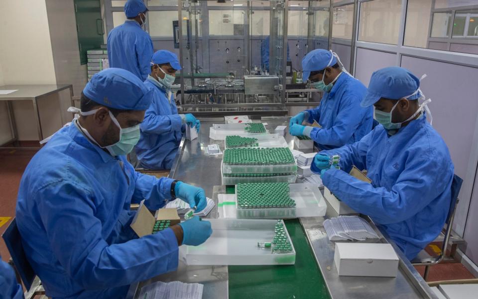 Employees pack boxes containing vials of Covishield, a version of the AstraZeneca vaccine, at the Serum Institute of India in Pune - Rafiq Maqbool/AP Photo