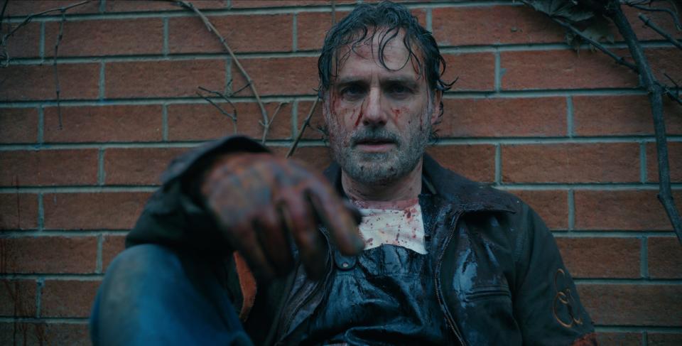 Andrew Lincoln sitting while covered in blood and sweat on "TWD: The Ones Who Live."