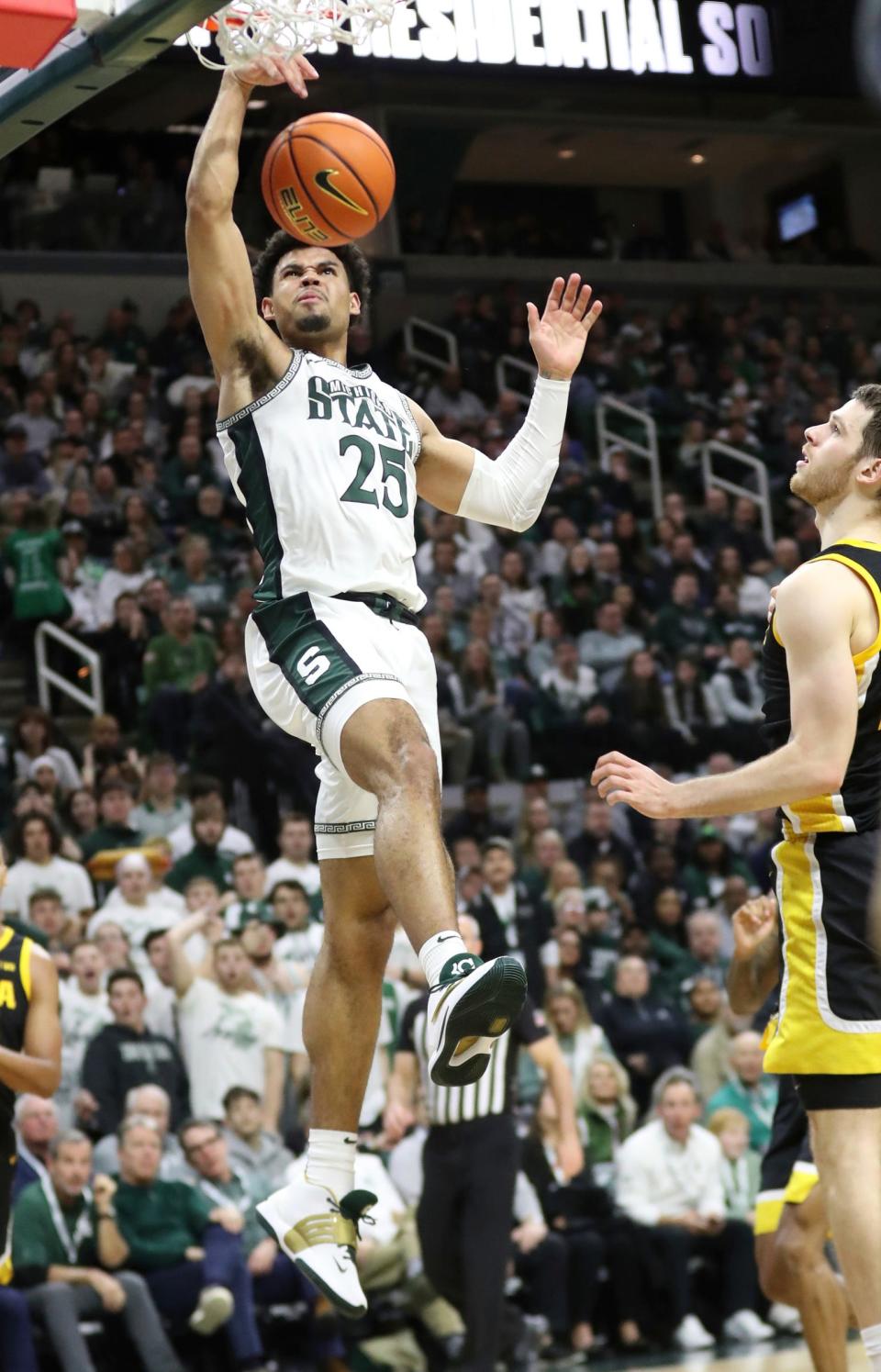 Michigan State Spartans forward Malik Hall (25) scores against Iowa Hawkeyes forward Filip Rebraca (0) during first half action Thursday, January 26, 2023.