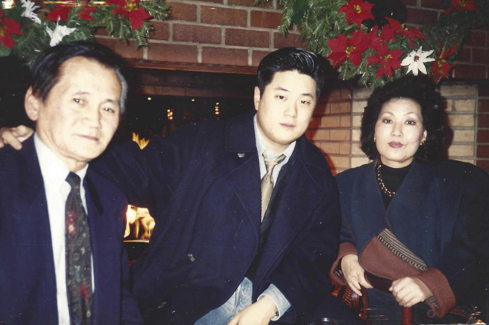 In this undated photo provided by Charlton Rhee, Rhee, a nursing home administrator from New York, poses for a photo with his parents, Man Joon Rhee and Eulja Rhee. Charlton Rhee, whose parents came to the U.S. from South Korea, lost both of them to COVID-19 as the virus surged in New York City. A joint analysis by The Associated Press and The Marshall Project found that Asian Americans join Black and Hispanic Americans among the hardest-hit groups, with deaths in each group up at least 30% this year. (Courtesy of Charlton Rhee via AP)