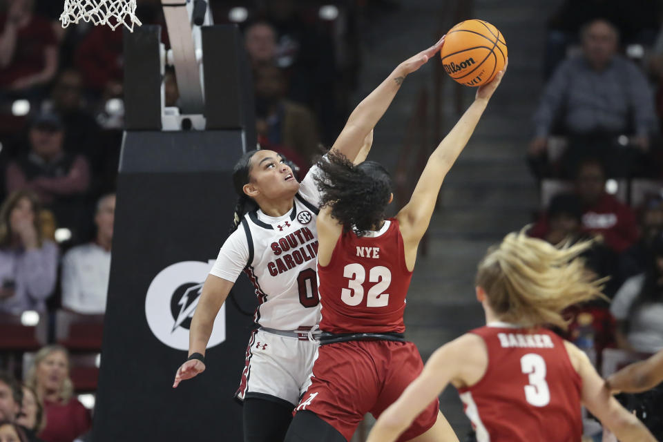 South Carolina guard Te-Hina Paopao (0) blocks a shot by Alabama guard Aaliyah Nye (32) during the first half of an NCAA college basketball game Thursday, Feb. 22, 2024, in Columbia, S.C. (AP Photo/Artie Walker Jr.)