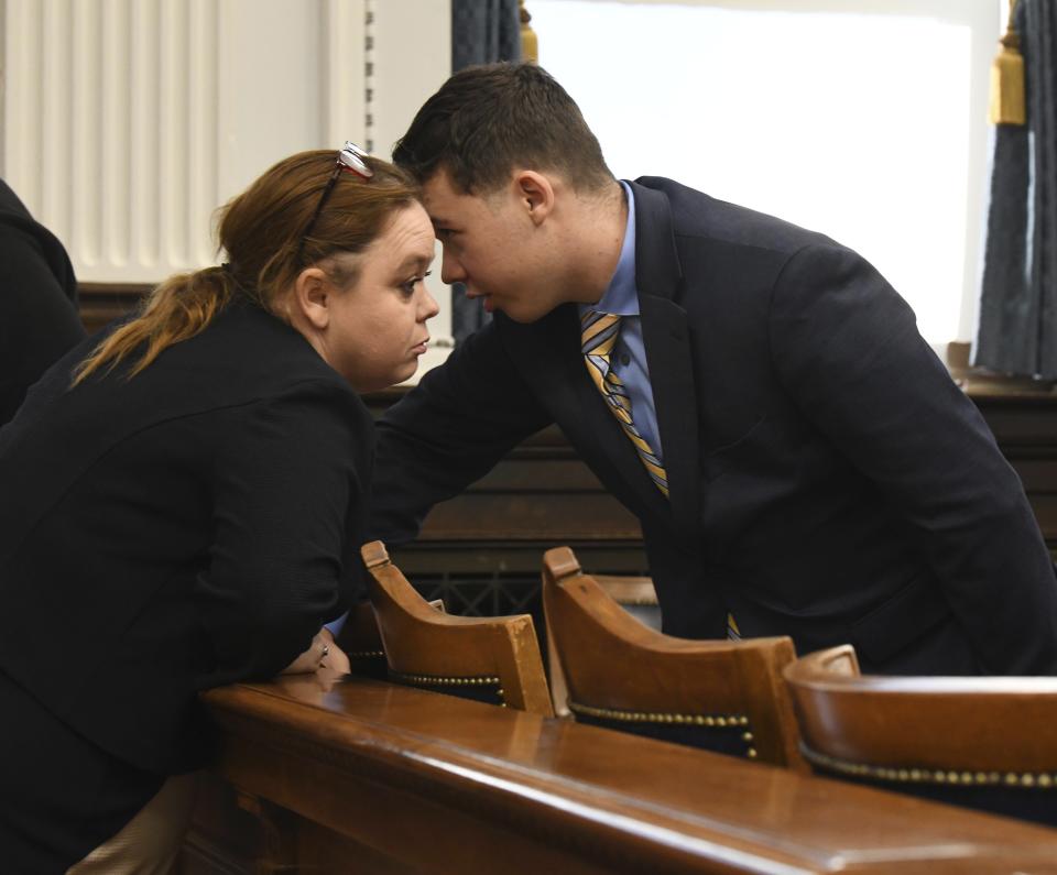 FILE - Wendy Rittenhouse, left, talks to her son Kyle Rittenhouse before the start of his trial at the Kenosha County Courthouse in Kenosha, Wisconsin, on Wednesday, Nov. 3, 2021. On Friday, Nov. 19, 2021, The Associated Press reported on stories circulating online incorrectly claiming that Wendy Rittenhouse drove her son across state lines and dropped him off at the protest in Kenosha, Wisconsin, on the night he shot three people in August 2020. (Mark Hertzberg/Pool Photo via AP, File)