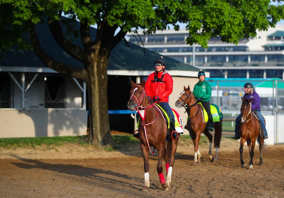 Assistant trainer Takahide Ando for Kentucky Derby contender Continuar, foreground, as assistant trainer Masanari Tanaka rides fellow Kentucky Derby horse Derma Sotogake after a workout at the track April 25, 2023 at Churchill Downs in Louisville, Ky.