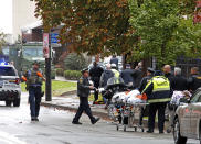 FILE - In this Oct. 27, 2018 file photo, first responders surround the Tree of Life Synagogue, rear center, in Pittsburgh, where a shooter opened fire and 11 people were killed in America's deadliest antisemitic attack. As the three-year mark since the massacre at the Tree of Life synagogue approaches, survivors are planning now-familiar annual rituals of remembrance, the criminal case involving the suspect plods on and the massacre site is in line for restoration. (AP Photo/Gene J. Puskar, File)