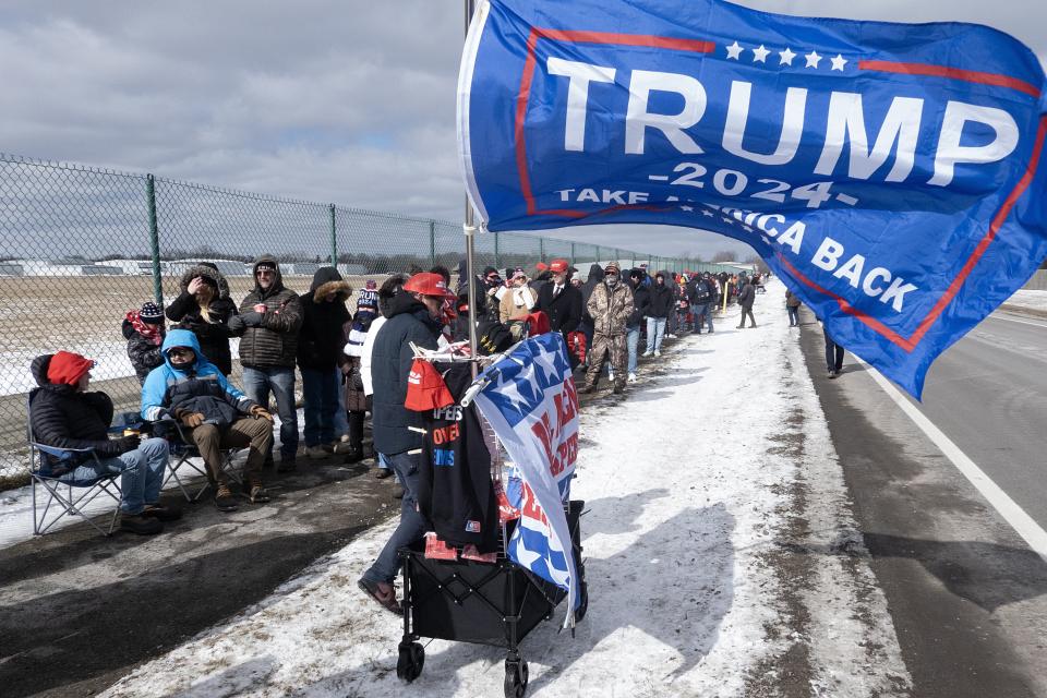 Supporters of Republican presidential candidate former President Donald Trump wait in line to attend a rally with the former president on Feb. 17, 2024 in Waterford, Michigan. People waited in lines for hours outside the event as temperatures held in the mid-20s and a strong wind cut through the crowd.