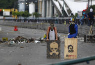 <p>Opposition supporters stand behind a barricade as the Constituent Assembly election was being carried out in Caracas, Venezuela, July 30, 2017. (Christian Veron/Reuters) </p>