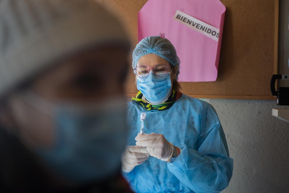 A health worker prepares a shot of the Pfizer COVID-19 vaccine at the Santa Maria Eugenia neighborhood in the outskirts of Montevideo, Uruguay, Monday, July 19, 2021. (AP Photo/Matilde Campodonico)