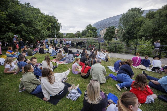 Taylor Swift fans outside the Aviva Stadium listen in to the concert 