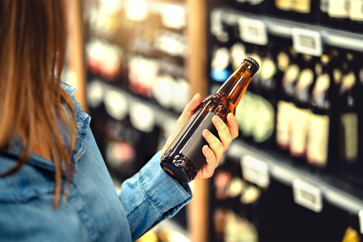 Woman holding bottle of beer