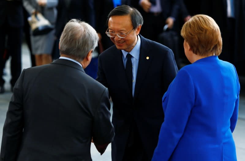 German Chancellor Angela Merkel and United Nations Secretary-General Antonio Guterres welcome Yang Jiechi, director of the Office of Foreign Affairs of the Communist Party of China, at the Libya summit in Berlin