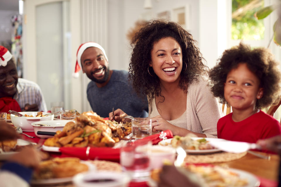 Family happy and enjoying Christmas dinner.  (Getty Images)