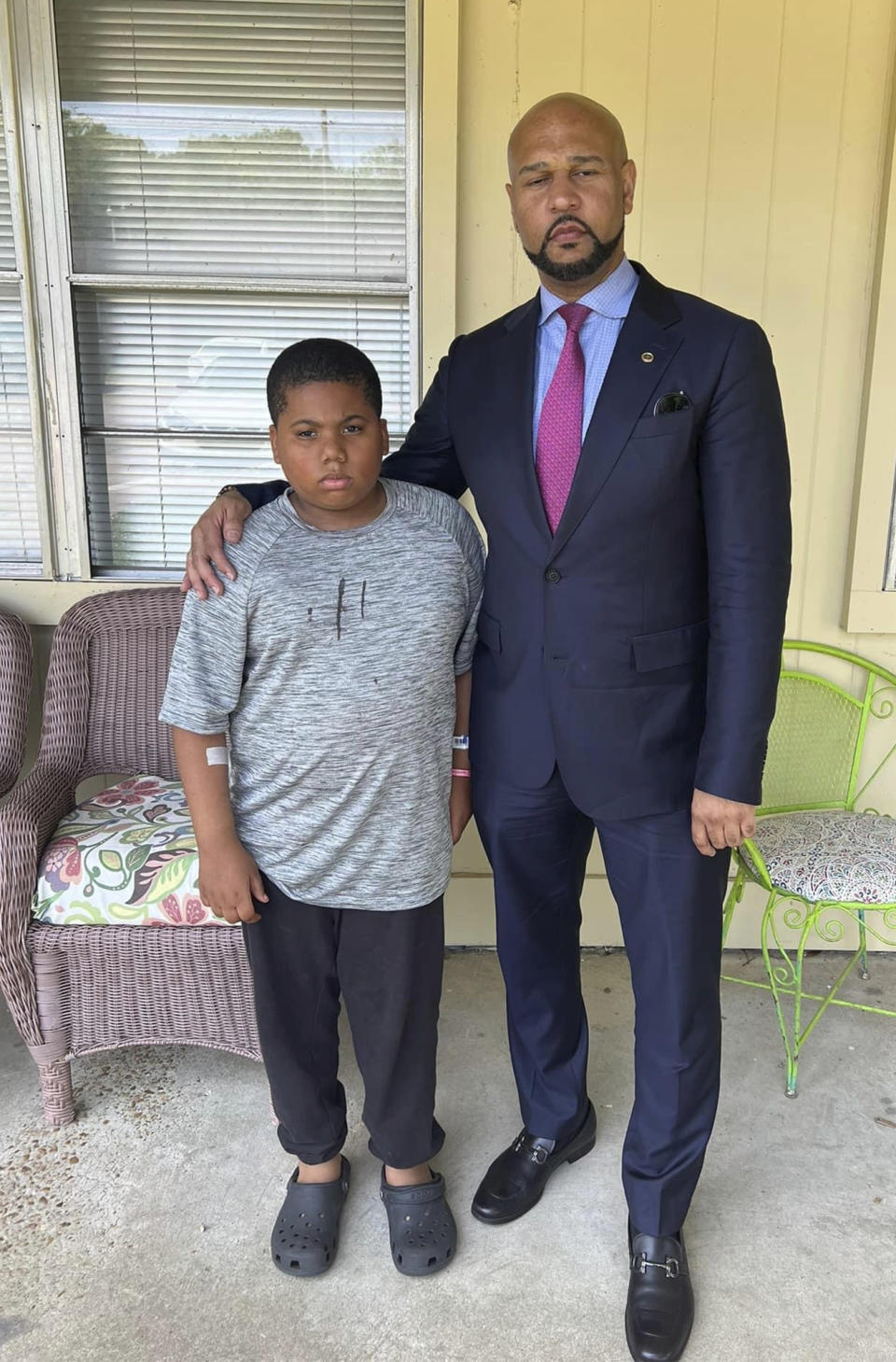 This undated photo provided by attorney Carlos Moore shows Moore, right, and his client, 11-year-old Aderrien Murry, at left. A Mississippi police officer who shot and wounded the unarmed 11-year-old boy in the child’s home has been suspended without pay, a city official said Tuesday, June 13, 2023. (Carlos Moore via AP)