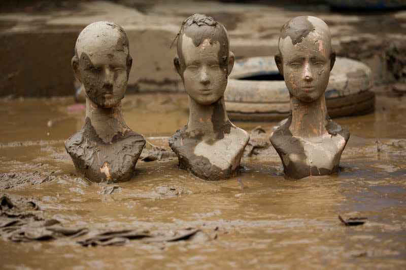 Mannequin heads are pictured at a residential area flooded in Bekasi