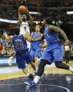 Memphis Grizzlies guard Tony Allen (9) shoots against Dallas Mavericks defenders Devin Harris (20); Dirk Nowitzki, rear, of Germany; and Jae Crowder (9) in the second half of an NBA basketball game Wednesday, April 16, 2014, in Memphis, Tenn. The Grizzlies won in overtime, 106-105. (AP Photo/Lance Murphey)